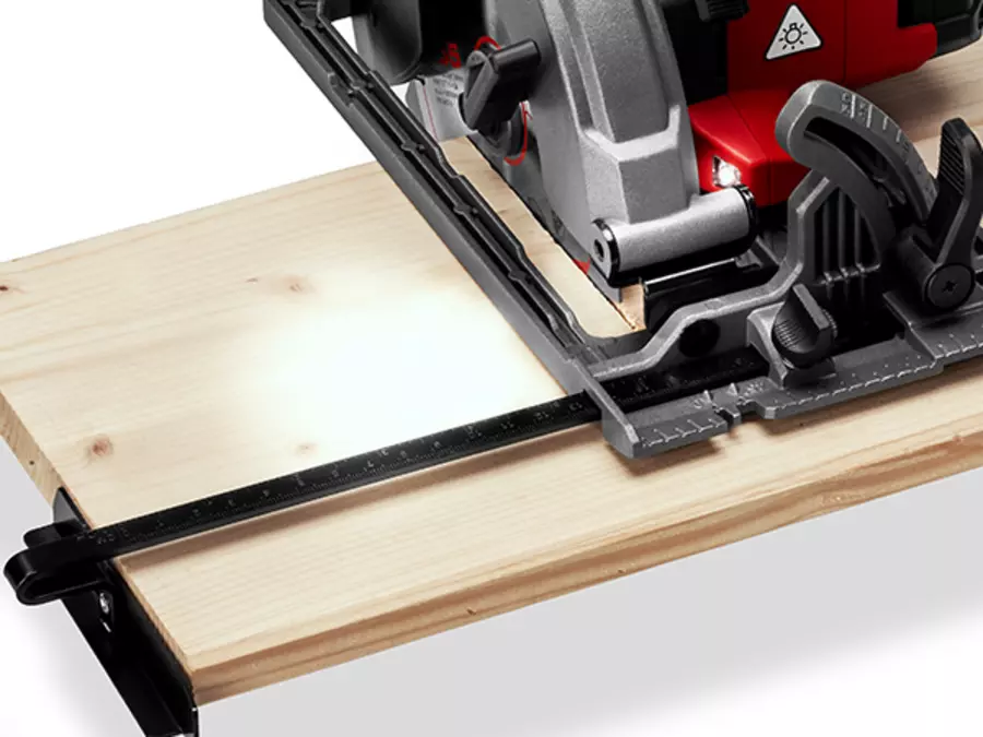 Activated LED light on the Einhell Cordless Handheld Circular Saw TE-CS 18/165-2 Li - Solo while cutting a wooden board.