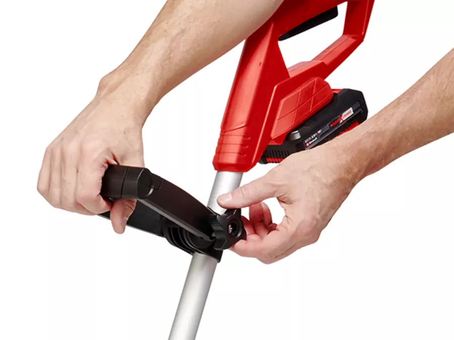 The adjustable auxiliary handle of the Einhell cordless grass trimmer GC-CLT 18/240 Li - Solo is being secured by hand.