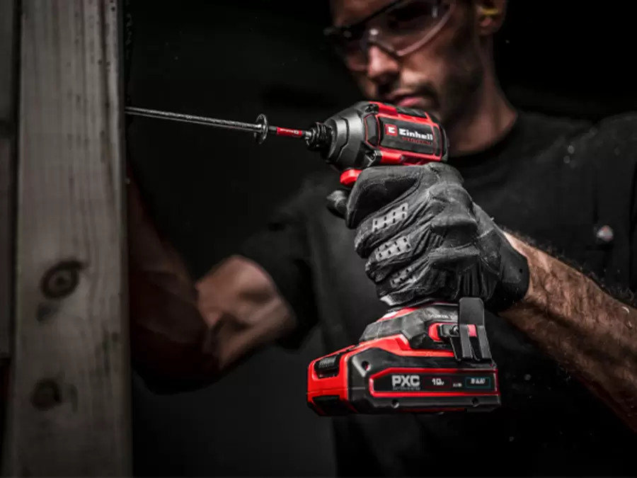 The Einhell Cordless Impact Driver TP-CI 18/250-C Li BL – Solo driving a screw into a wooden beam.