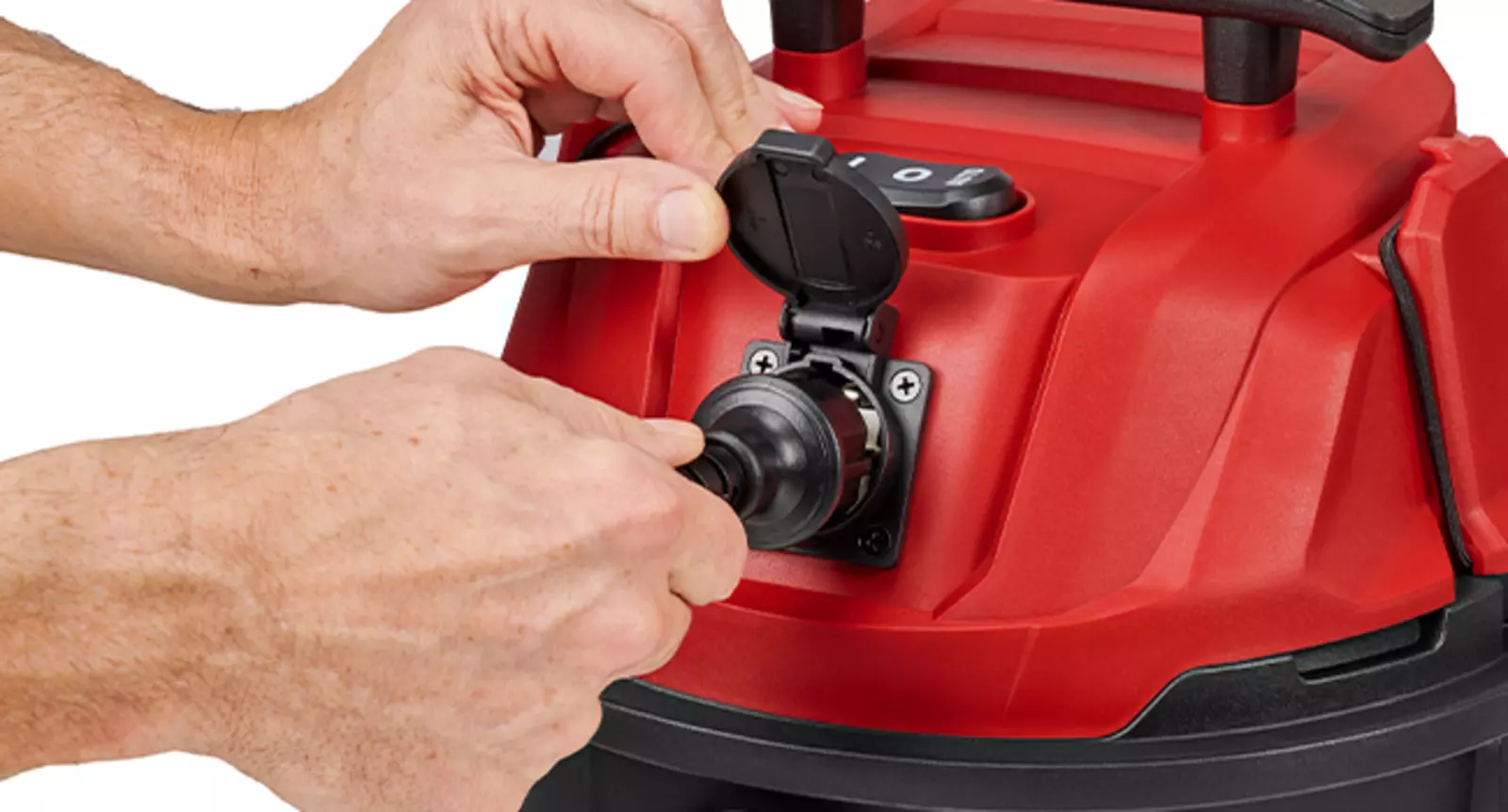 Due mani azionano la presa automatica sull'aspirapolvere a umido e a secco Einhell TC-VC 2555 A.