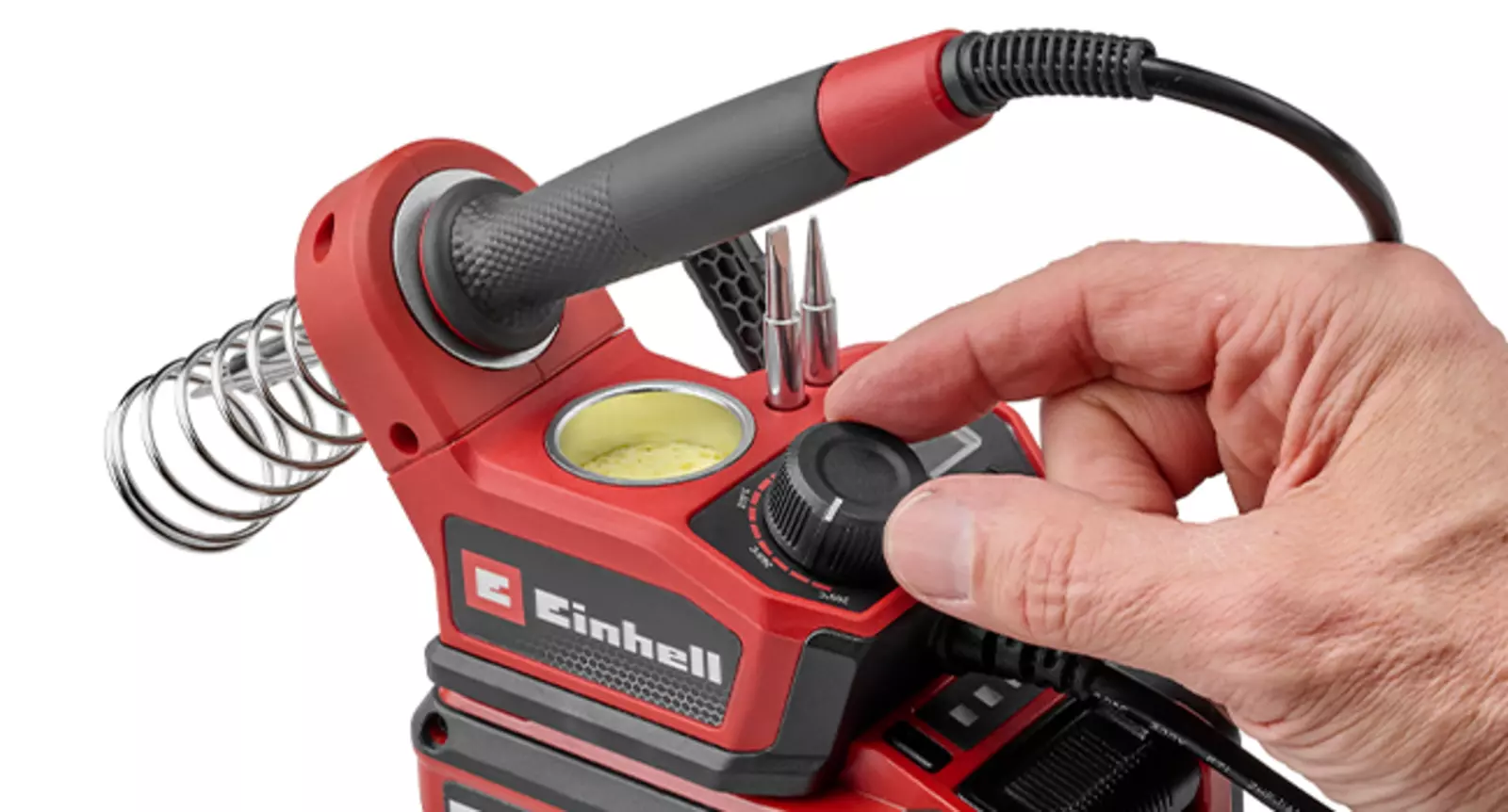The Einhell cordless soldering iron TE-SI 18/480 Li E - Solo being operated by hand using the rotary temperature control.