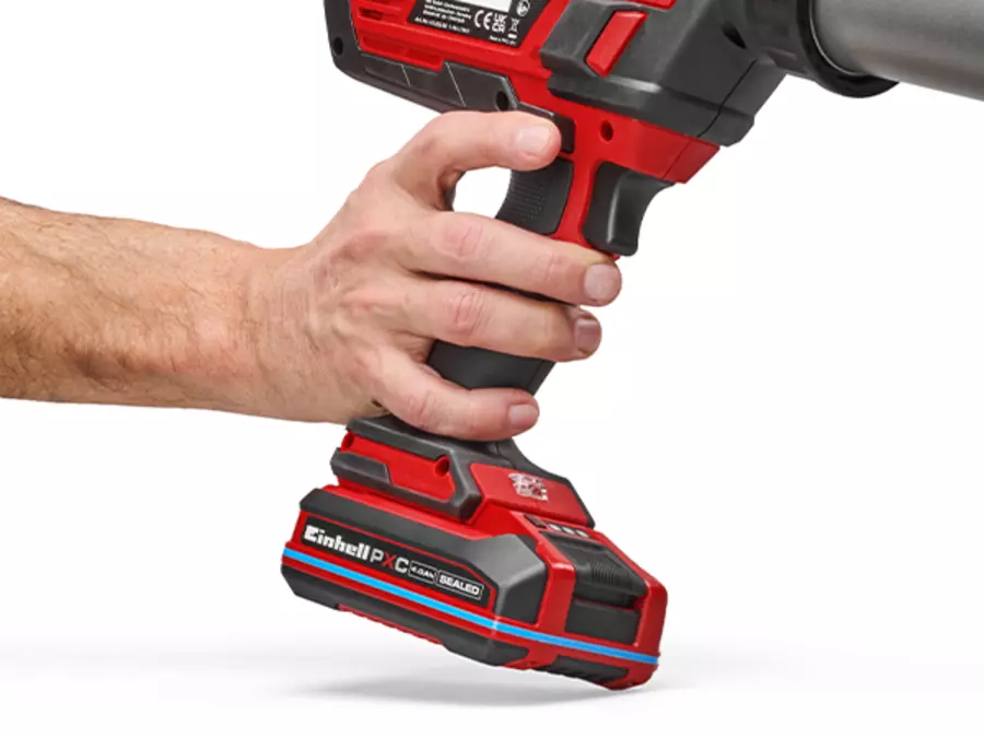 The Einhell cordless cartridge gun TE-SG 18/600 B Li - Solo featuring soft grip, held in one hand.