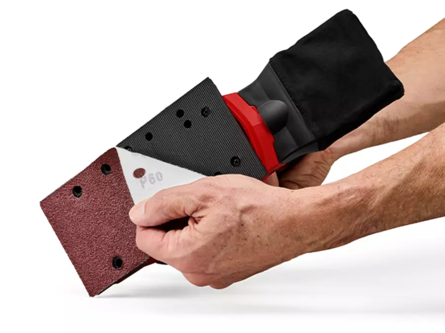 The Einhell orbital sander TC-OS 250 in red and black shows the hook-and-loop fastening for attaching sandpaper.