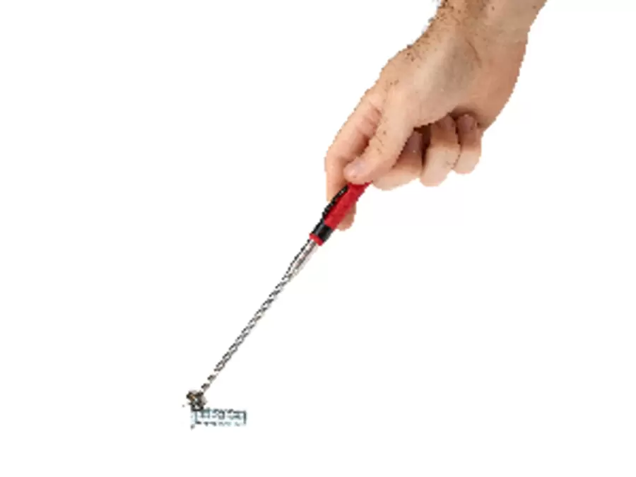 Hand holding an extended red and black telescopic magnetic pick-up tool picking up a screw.