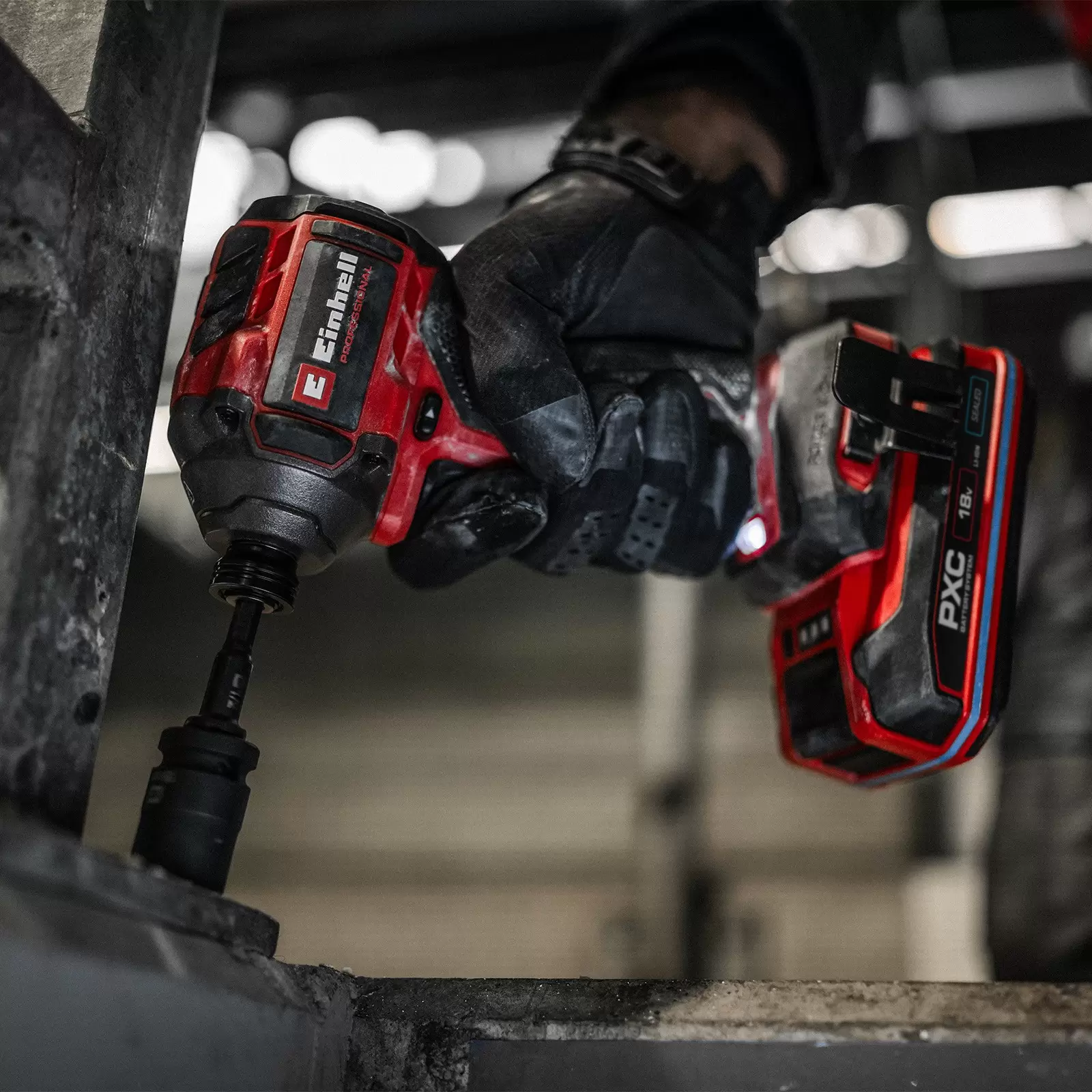 The Einhell Cordless Impact Driver TP-CI 18/250-C Li BL – Solo in use in a dark environment.