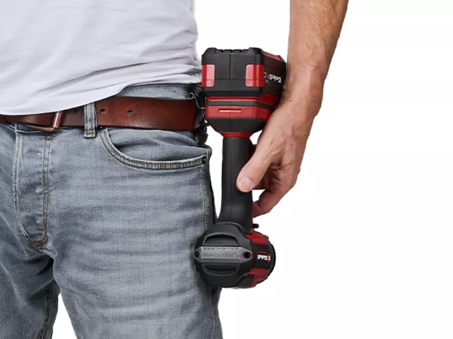 The Einhell cordless impact wrench TP-CW 18/750-C Li BL is carried on a belt hook attached to the waistband.