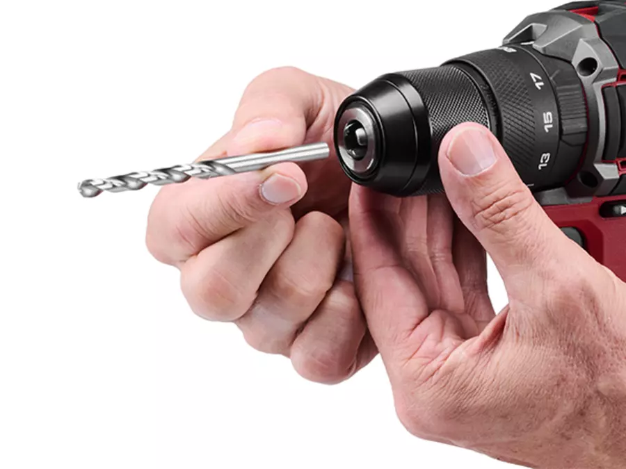 The Einhell Professional cordless impact drill TP-CD 18/50-C Li-i BL (2x3Ah) featuring a detailed view of the metal quick-action drill chuck with a hand inserting a drill bit on a white background.