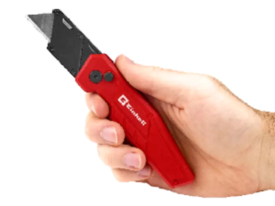 Hand holding a red Einhell utility knife with extended blade.