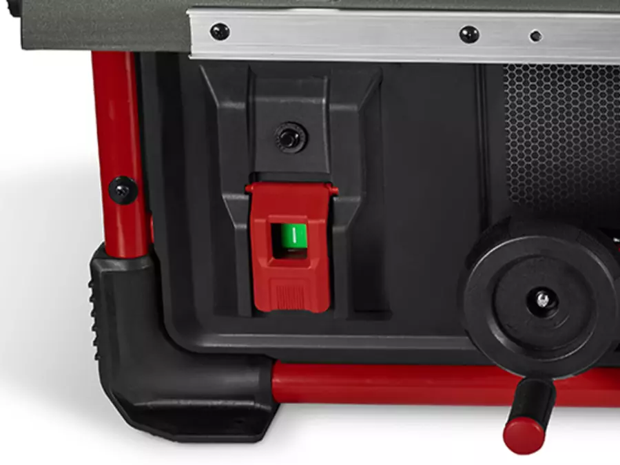 Close-up of the green on/off switch on the front of the Einhell table saw TE-TS 10 T.