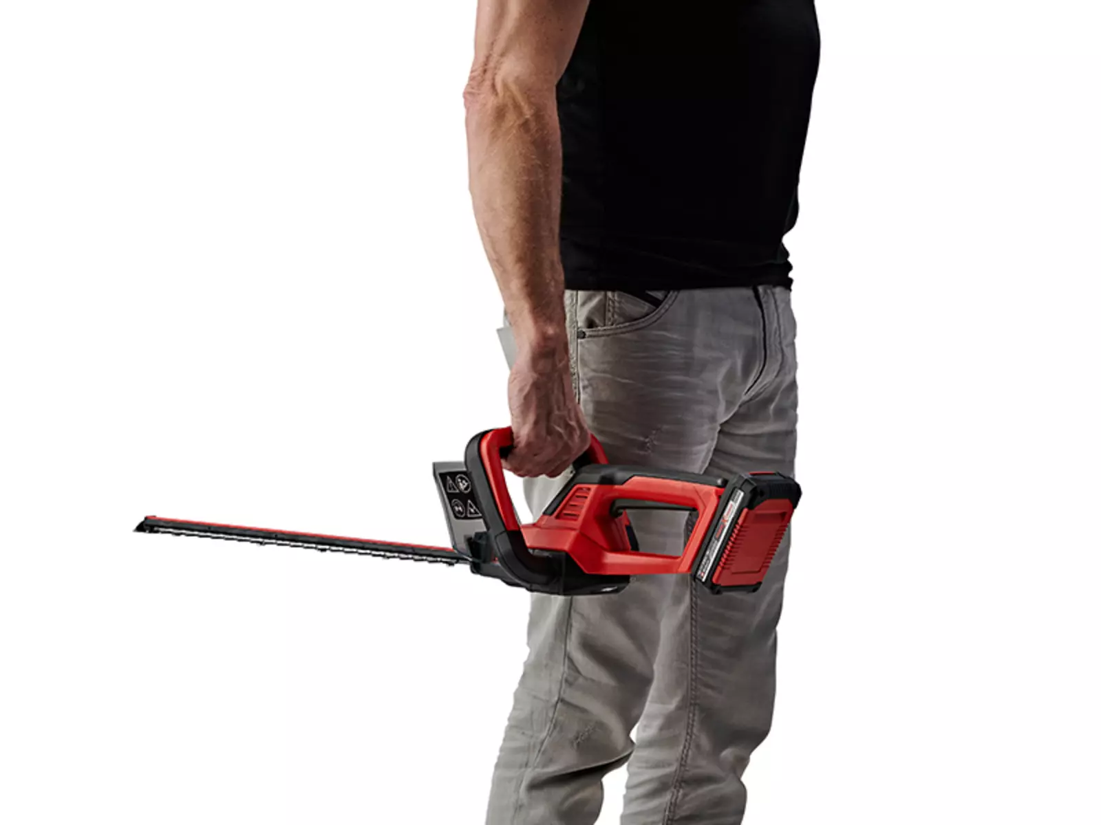 A man holds the Einhell cordless hedge trimmer GC-CH 18/40 Li Kit pointing downward in his right hand.