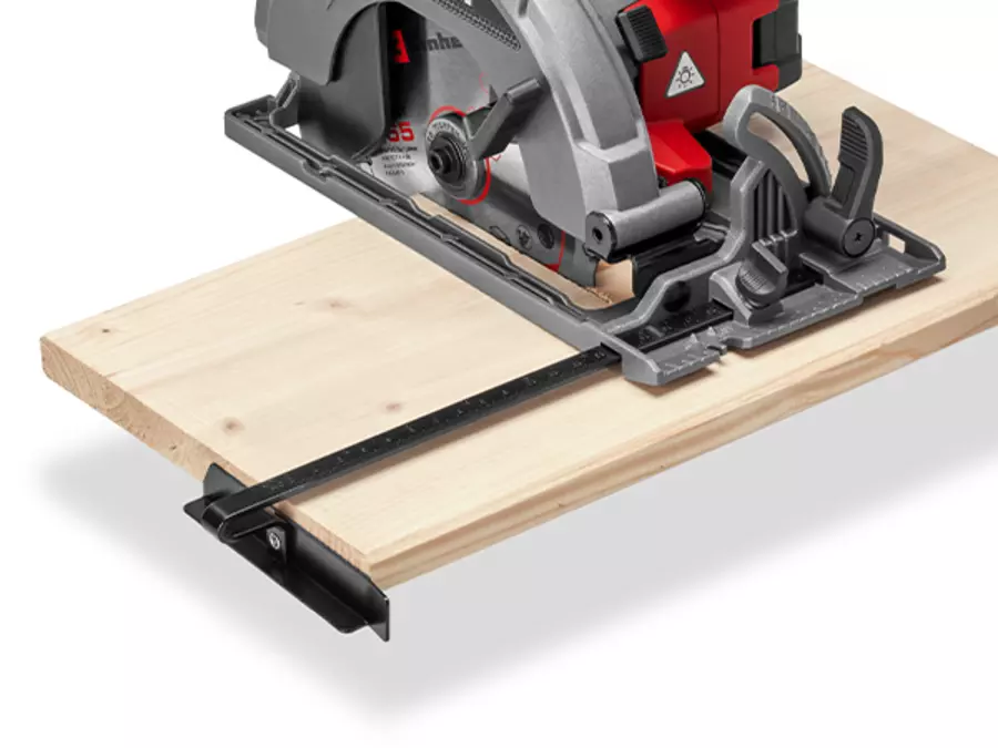The Einhell Cordless Handheld Circular Saw TE-CS 18/165-2 Li - Solo with mounted parallel guide while cutting a wooden board.