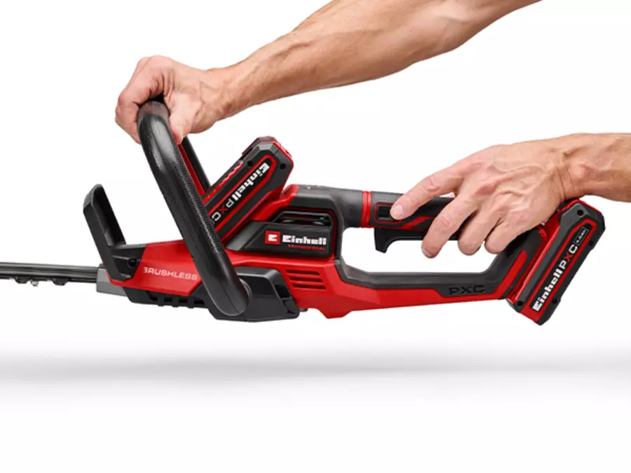 Two hands operate the Einhell cordless hedge trimmer GP-CH 36/65 Li BL-Solo to demonstrate handling.