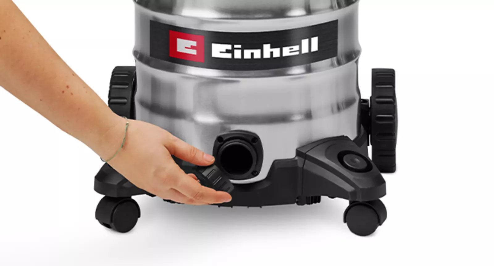 A hand opens the water drain plug at the bottom edge of the Einhell wet/dry vacuum cleaner TC-VC 3055 SA.