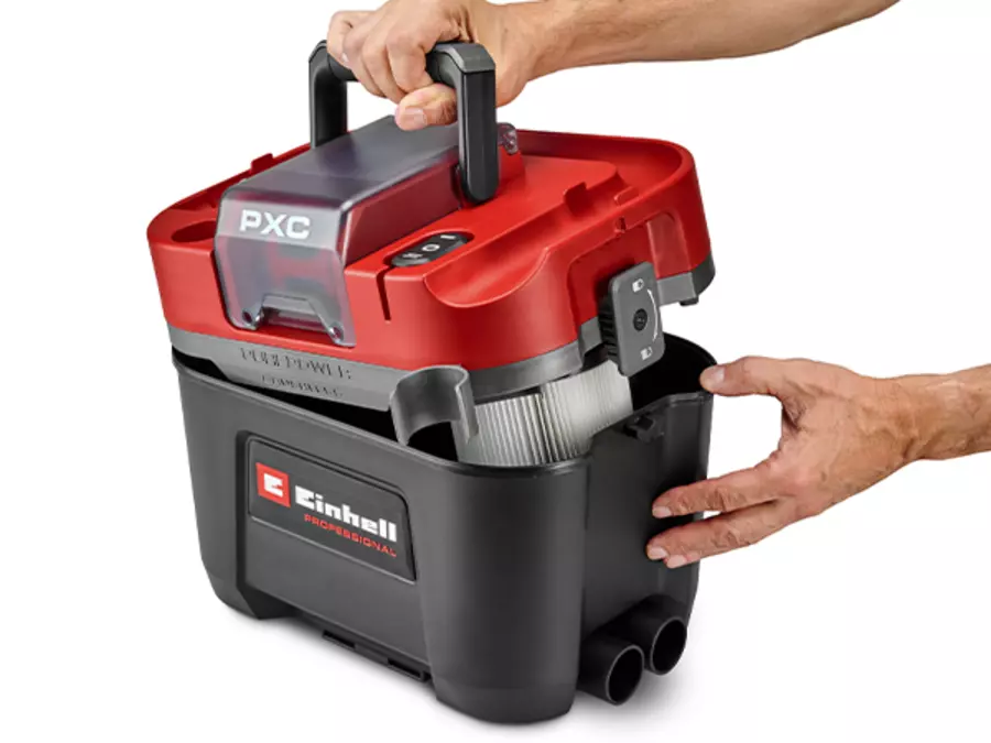 The Einhell Cordless Wet/Dry Vacuum Cleaner TP-VC 18/10 Li BL L-Solo is being opened at the side twist locks, revealing the dust container.