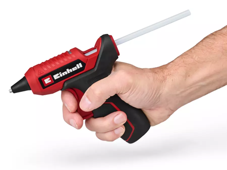 The Einhell cordless hot glue gun TE-CG 18/7 Li with 2-finger trigger is held in the hand.