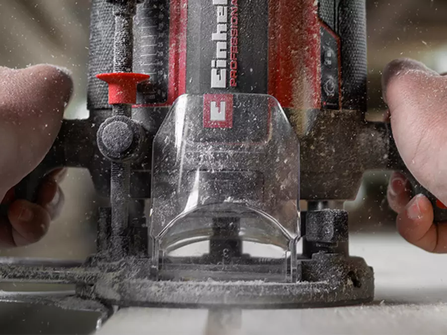 Front view of the Einhell TP-RO 1400 E router in operation with transparent chip guard.