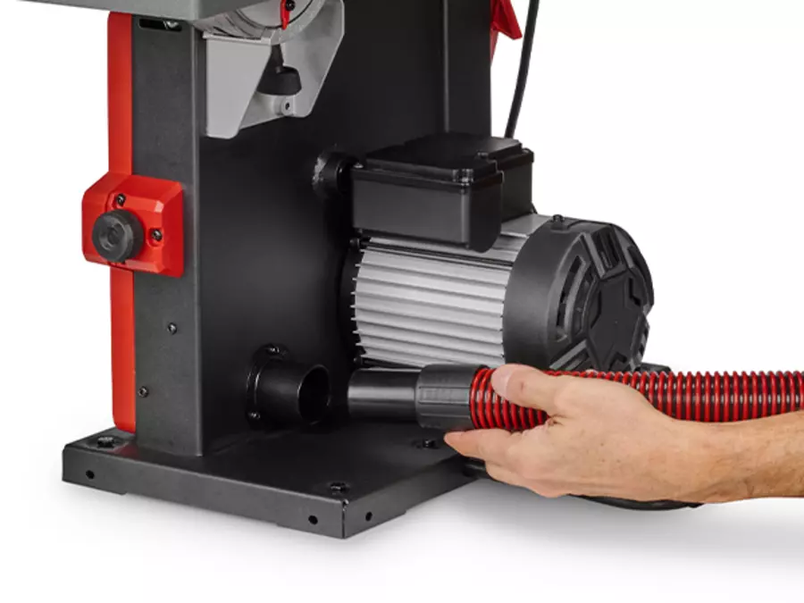 One hand operates the extraction adapter for dust extraction on the Einhell band saw TC-SB 245/1 L.