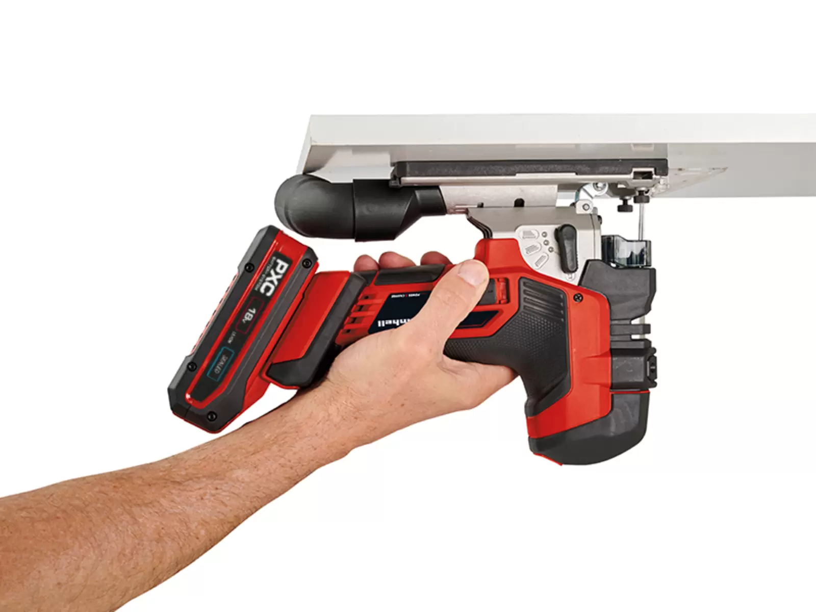 A man uses the Einhell cordless jigsaw TP-JST 18/135 Li BL to saw underneath a tabletop edge.