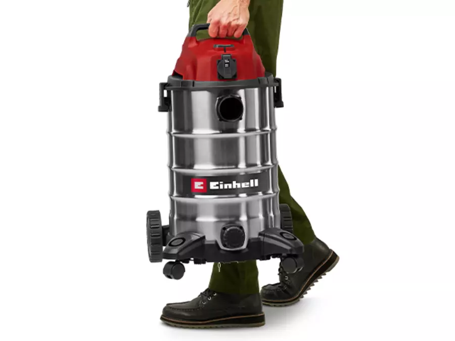 The Einhell wet/dry vacuum cleaner TC-VC 3055 SA is transported with one hand on the carrying handle.