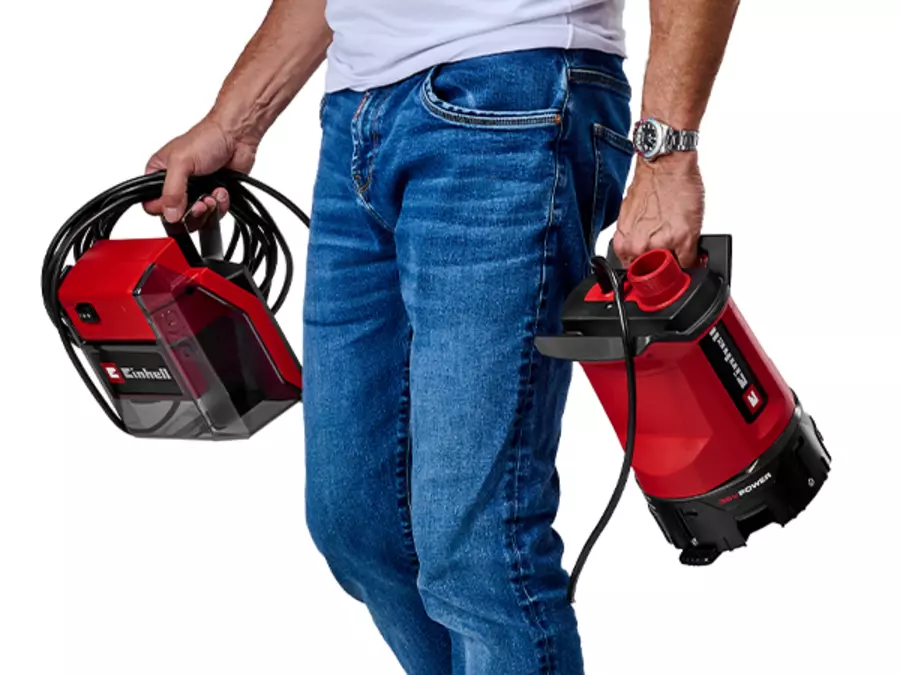 Person carrying the Einhell cordless dirty water pump GE-DP 36/35 LL Li-Solo with one hand by the integrated handle.