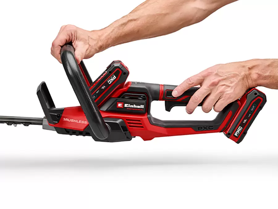 Two hands operate the Einhell cordless hedge trimmer GP-CH 36/65 Li BL-Solo to demonstrate handling.