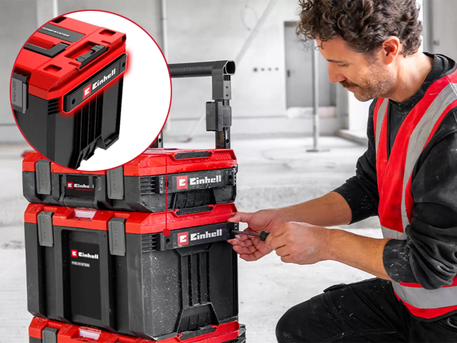 Einhell Pro System Rolling Workshop SEALED with side rails, with accessories being attached by hand.