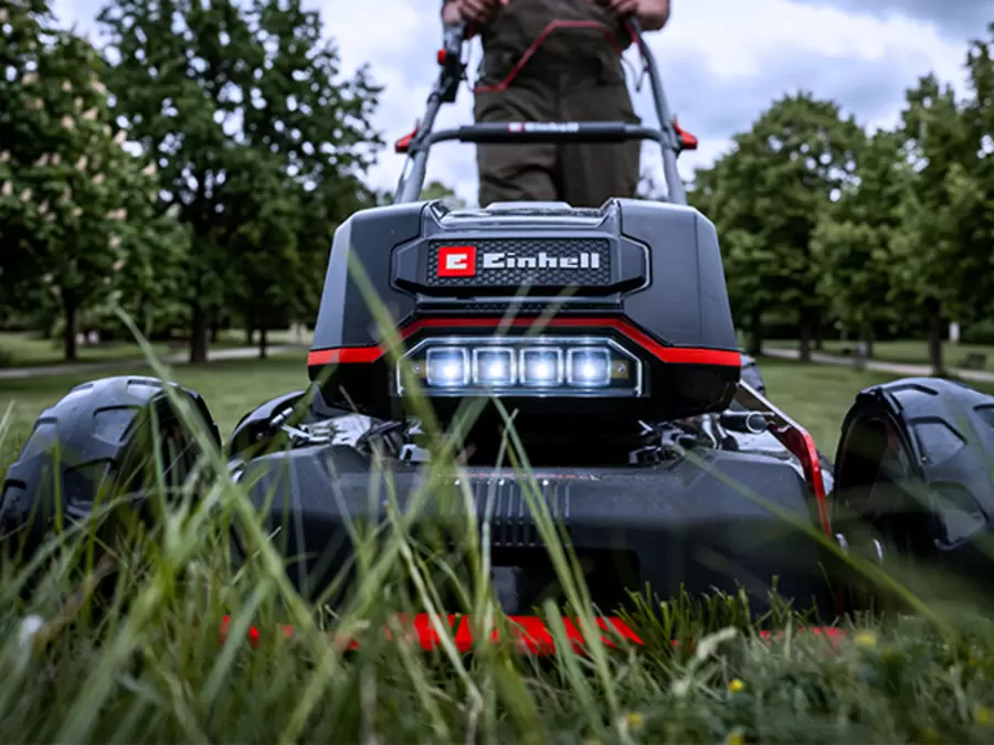 Front view of the Einhell Professional 36V 470mm Self-Propelled Steel Deck Lawn Mower Kit with LED light switched on, shown on a white background.