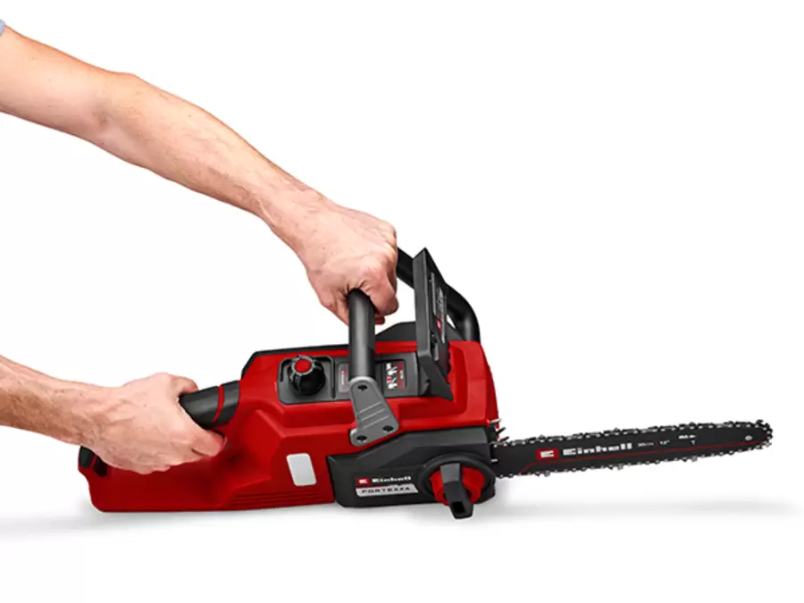 The Einhell cordless chainsaw FORTEXXA 18/30 is held by its ergonomic handle with soft-grip surfaces.