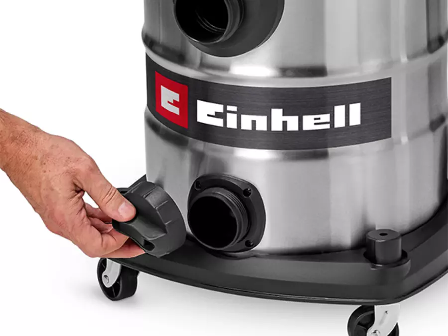 A hand unscrews the water drain plug at the bottom of the stainless steel tank.