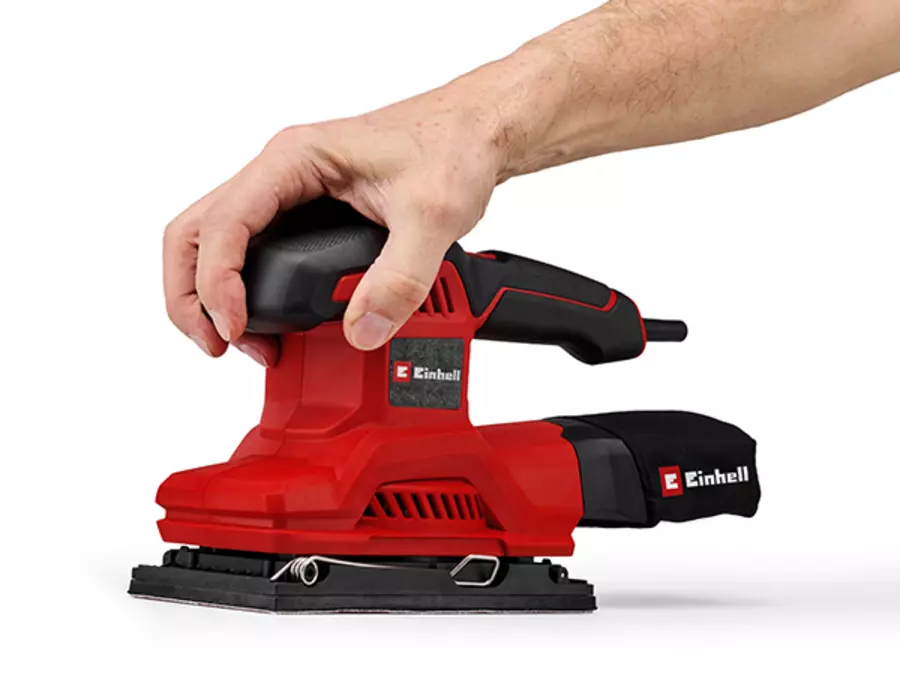 The Einhell orbital sander TC-OS 250 in red and black shows the soft grip handle for a secure hold.