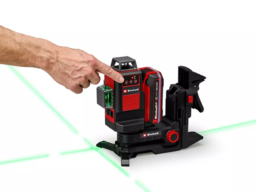 A finger points to the control buttons for the individually adjustable lasers on the Einhell cordless cross line laser TE-LL 18/360 G.