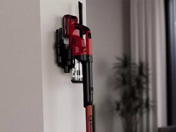 The Einhell cordless stick vacuum cleaner TE-SV 18 Li is positioned upright in a wall mount with charging function.