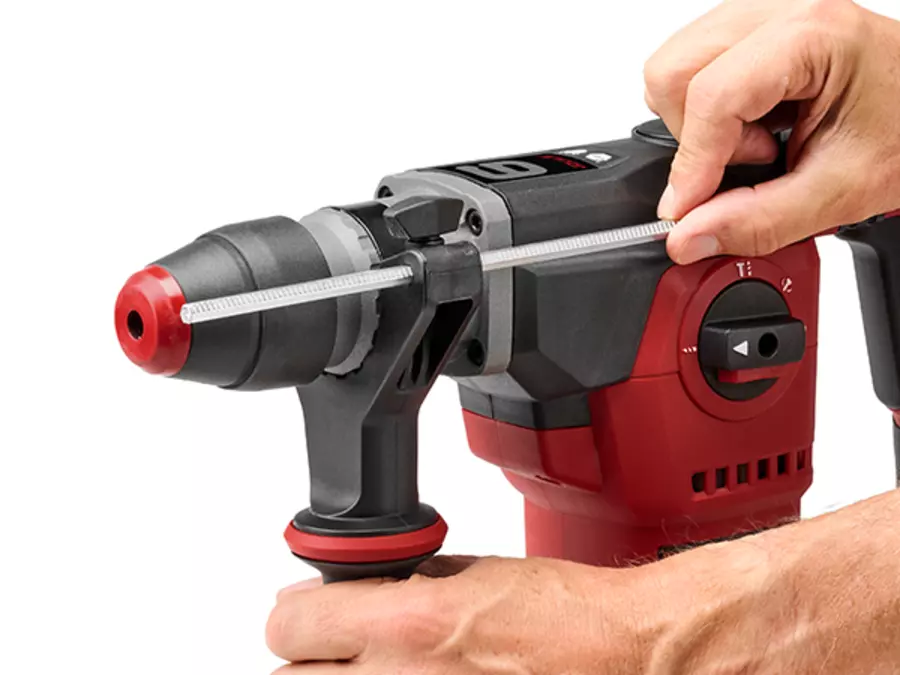 A hand adjusts the continuously variable metal depth stop on the Einhell rotary hammer TE-RH 34/6 4F +4.