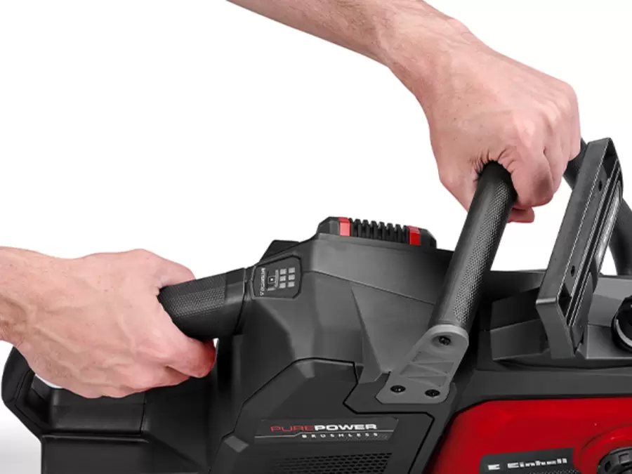 Two hands holding the Einhell Professional 36V Brushless 400mm Chainsaw by its soft-grip handles on a white background.