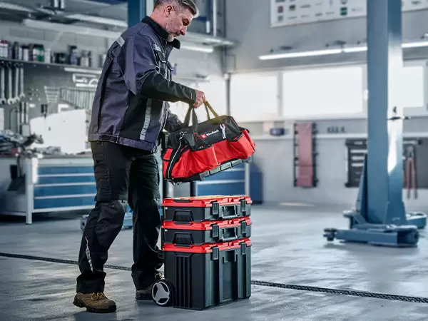 Einhell Pro System Tool Bag mounted to a stacked Pro System storage tower being moved across a worksite.